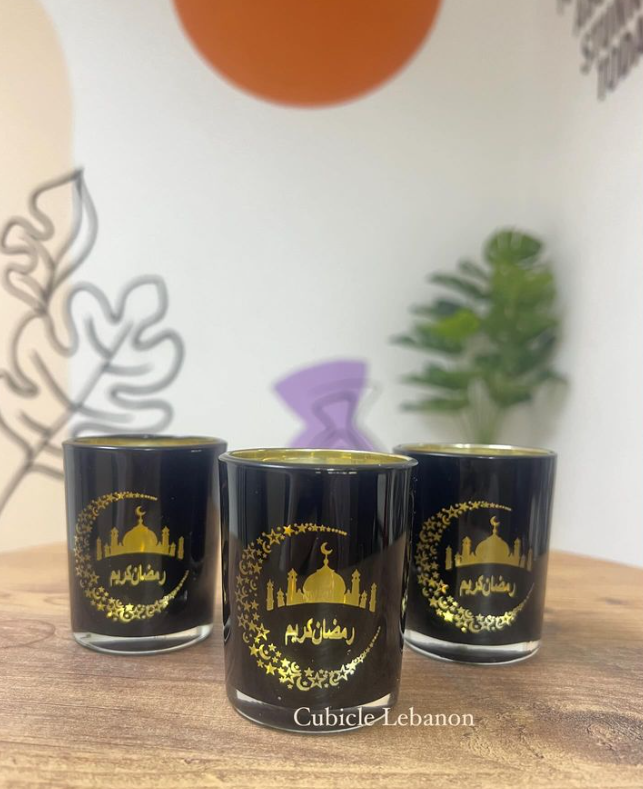 A set of three black colored cups with gold-colored Ramadan-themed decorations
