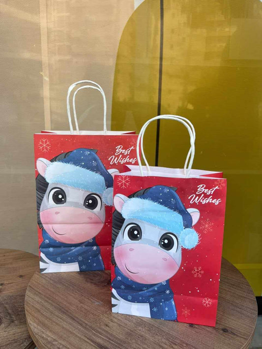 Cow Print Christmas Gift Bags, two red bags with cartoon cows in winter hats